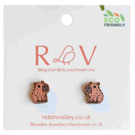 Don't worry, be capy with these hand painted Capybara earrings, made from cherrywood. Perfectly petite at 1 x 1.2 cm, these delicate accessories are responsibly presented in eco-friendly packaging. Steal the spotlight with these unique and cute earrings!