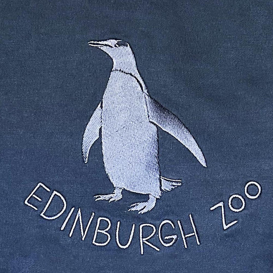 Stay warm with our Edinburgh Zoo Penguin Sweatshirt in Navy with large embroidered penguin Edinburgh Zoo Logo. This hoody is a standard fit and is made from cotton with fleeceback inner, ribbed cuffs, neck and hem.
Watch our Edinburgh Zoo Penguins live here.