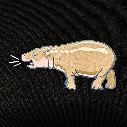 Hip Hippo Hooray for our new Haggis The Hippo T-shirt, made with 100% cotton. This black tee is perfect for hippo lovers looking to show their admiration for Scotland's cutest Pygmy Hippo calf.
Black T-shirt with Haggis the Hippo pocket print, Edinburgh Zoo flag Logo on hem and Edinburgh Zoo neck label.