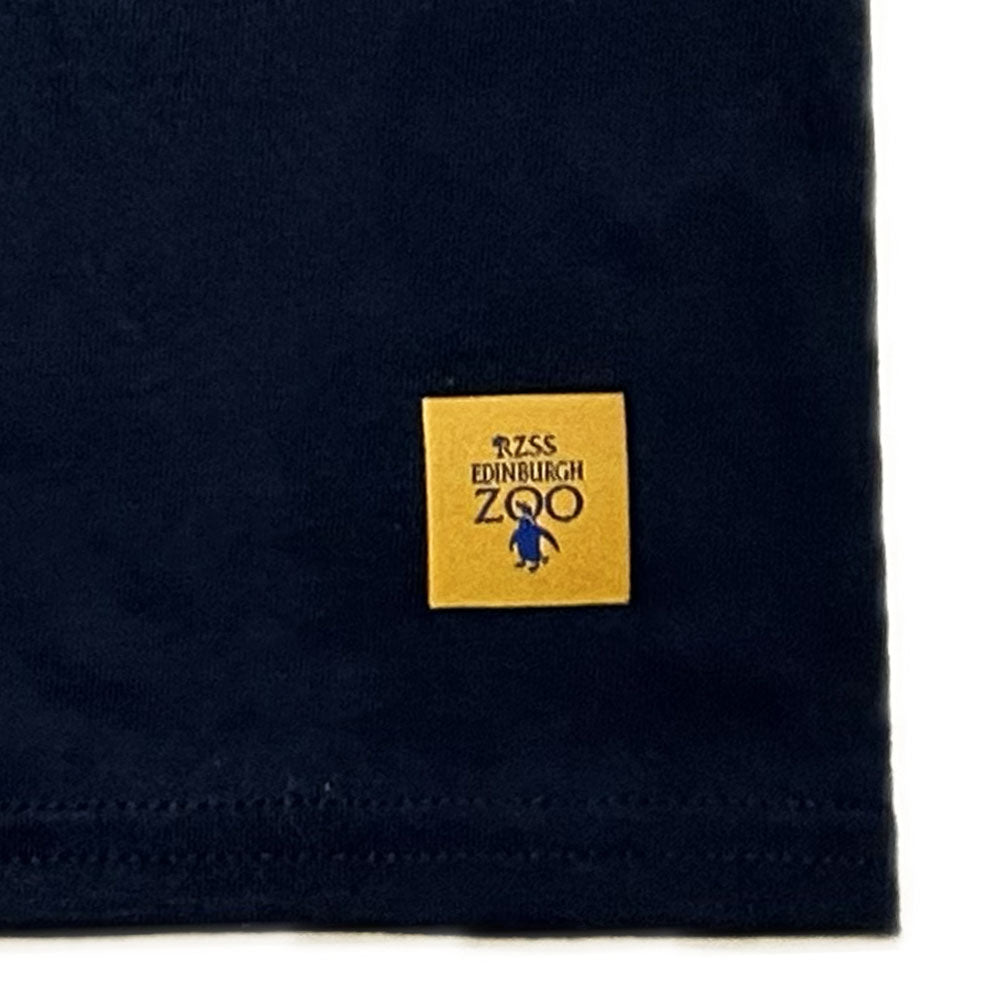 Make a splash with this stylish Edinburgh Zoo Penguin T-shirt! Made with 100% cotton, this navy tee is perfect for any animal-lover looking to add a dash of quirk to their wardrobe. Go wild and show your cool side with this adorable penguin print!