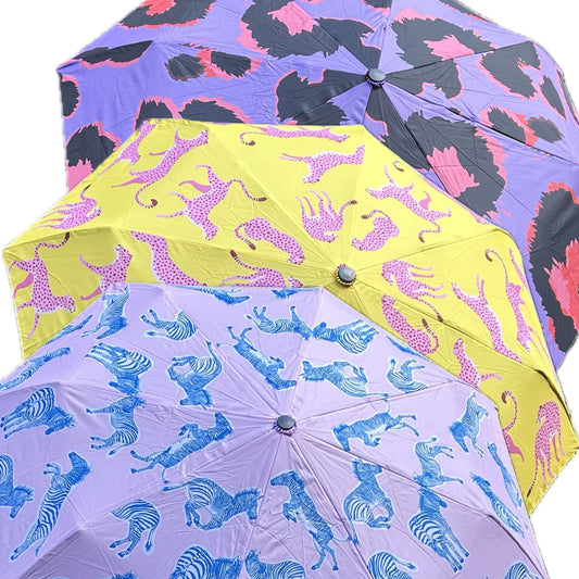 Cheer up a rainy day with these bright and colourful Animal Print Travel Umbrellas. Made from recycled polyester with wooden comfort handle and easy carry strap, this brolly is good for the environment as well as keeping you dry. Neatly compact, this folding travel size umbrella is perfect for taking with you on a day out.

Choose from Cheetah, Zebra or Leopard print designs.