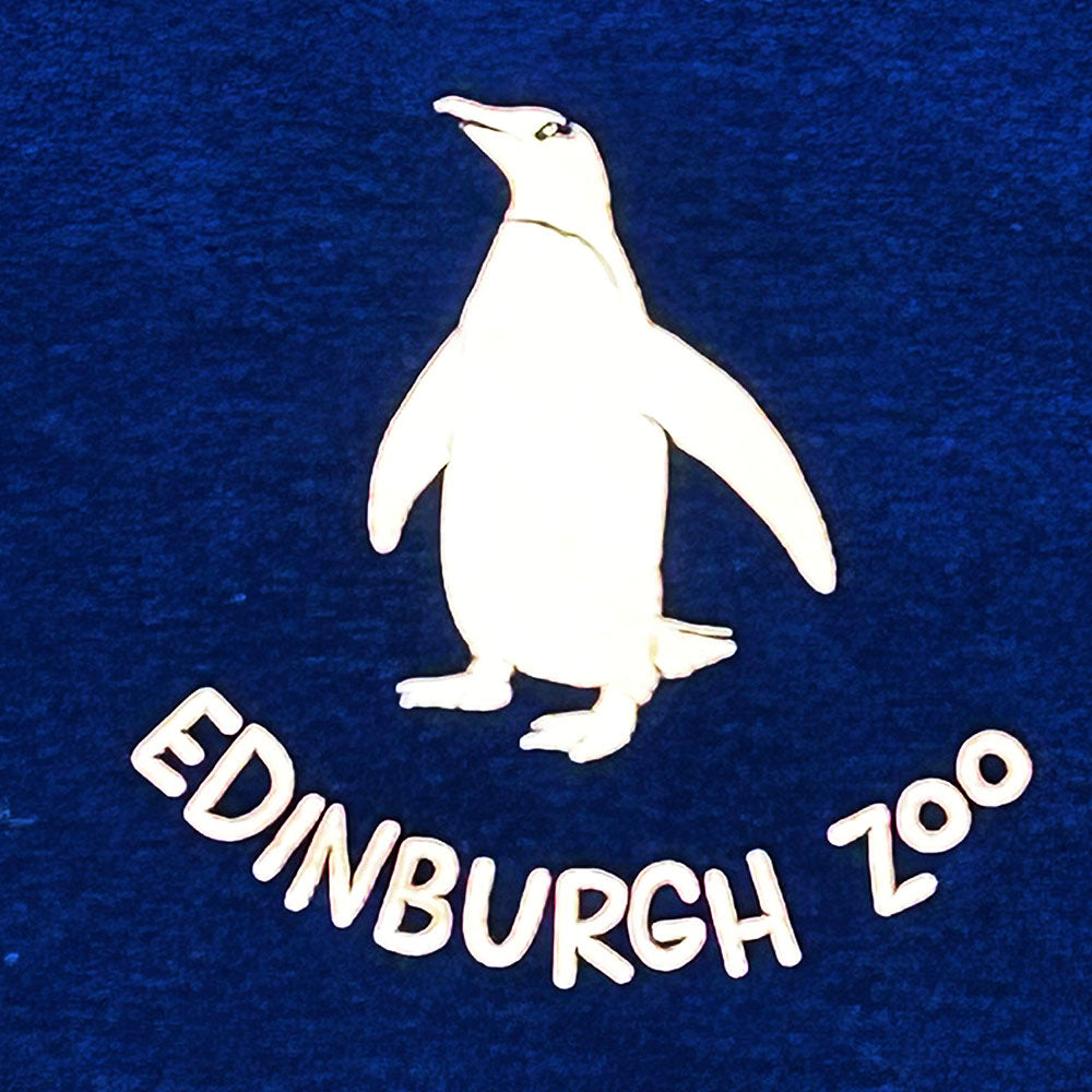 Make a splash with this stylish Edinburgh Zoo Penguin T-shirt! Made with 100% cotton, this navy tee is perfect for any animal-lover looking to add a dash of quirk to their wardrobe. Go wild and show your cool side with this adorable penguin print!